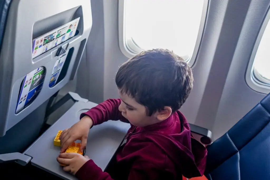 Boy playing with toy on plane