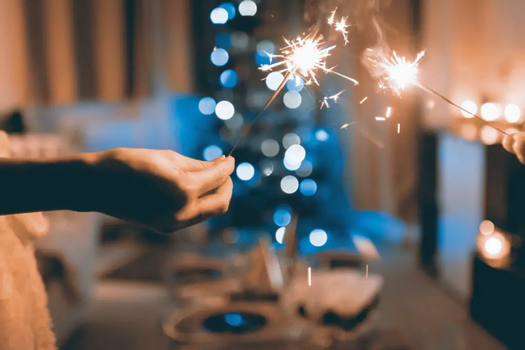 Close Up Photograph of Two Person Holding Sparklers