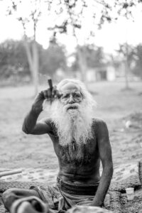 Elderly Sadhu Smoking a Cigar