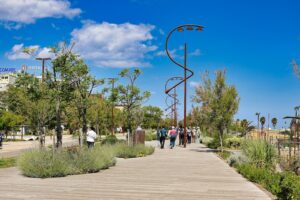 a group of people walking down a wooden walkway