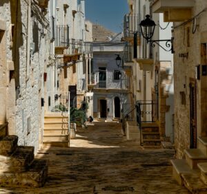 a narrow street with stone buildings and stairs