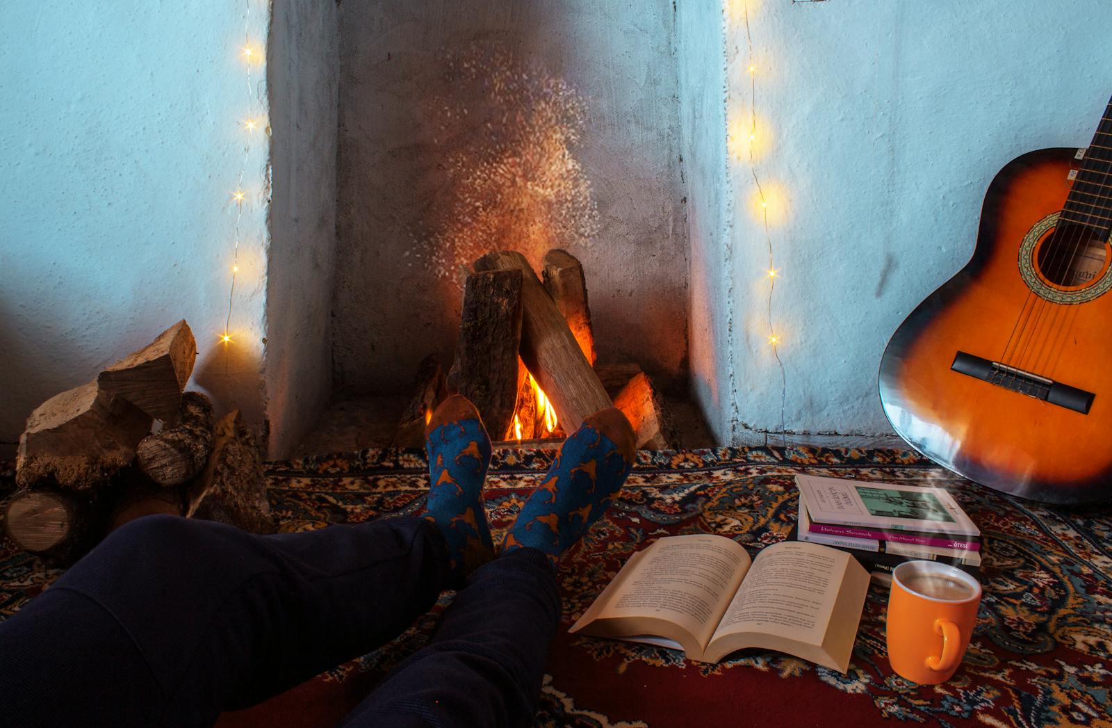 Piedi caldi vicino al camino con calze pesanti